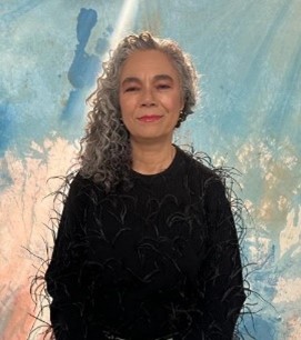 A person with grey hair and a black dress