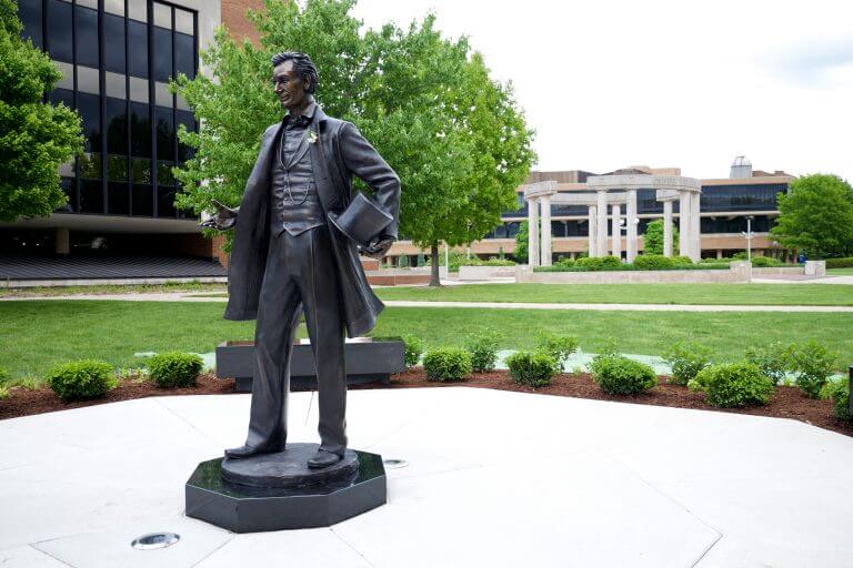 Abraham Lincoln statue on UIS campus in front of collonade
