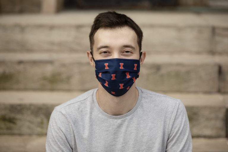 male student with blue and orange block-I logo face mask